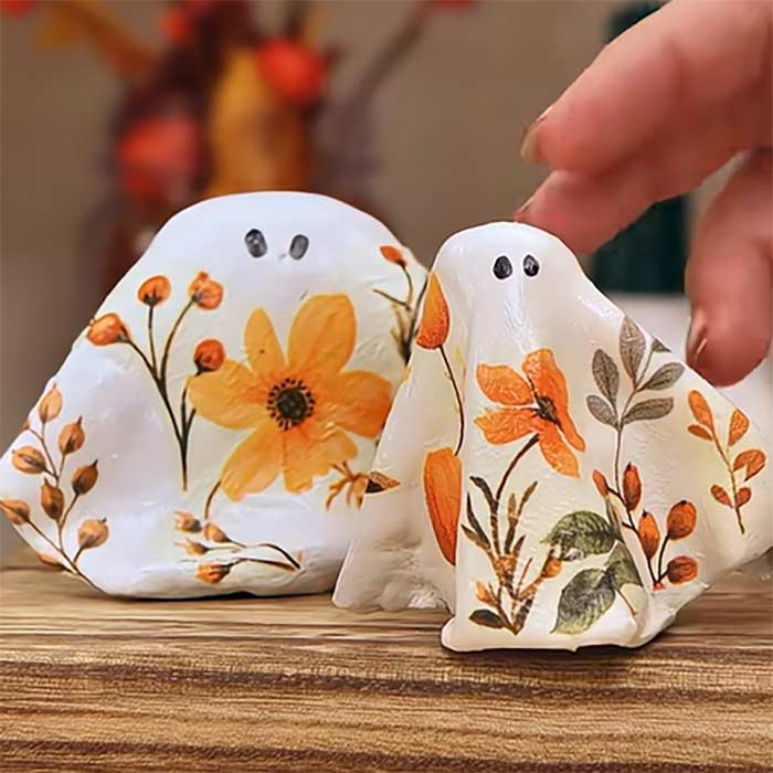 Two decoupage ghost decorations made out of air dry clay.
