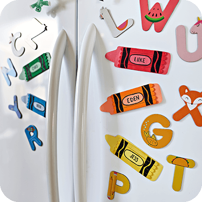 Colorful DIY magnets in Crayola Crayon shapes with kids' name