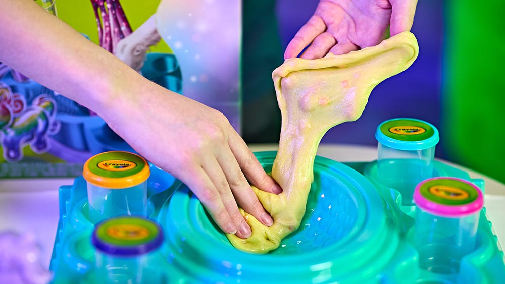 hands mixing goo in all-in-one-sensory station.