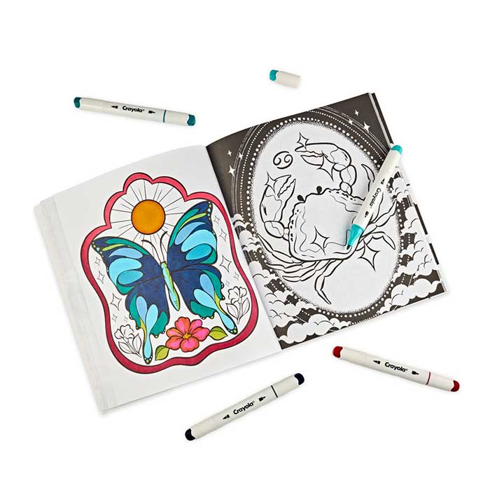 Mercury in Retrograde Adult Coloring Book, 32 pages. Open book with partially colored pages surrounded by crayola alcohol markers.
