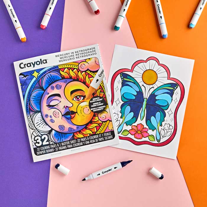 Mercury in Retrograde Adult Coloring Book, 32 pages. Book and partially colored page surrounded by crayola alcohol markers.