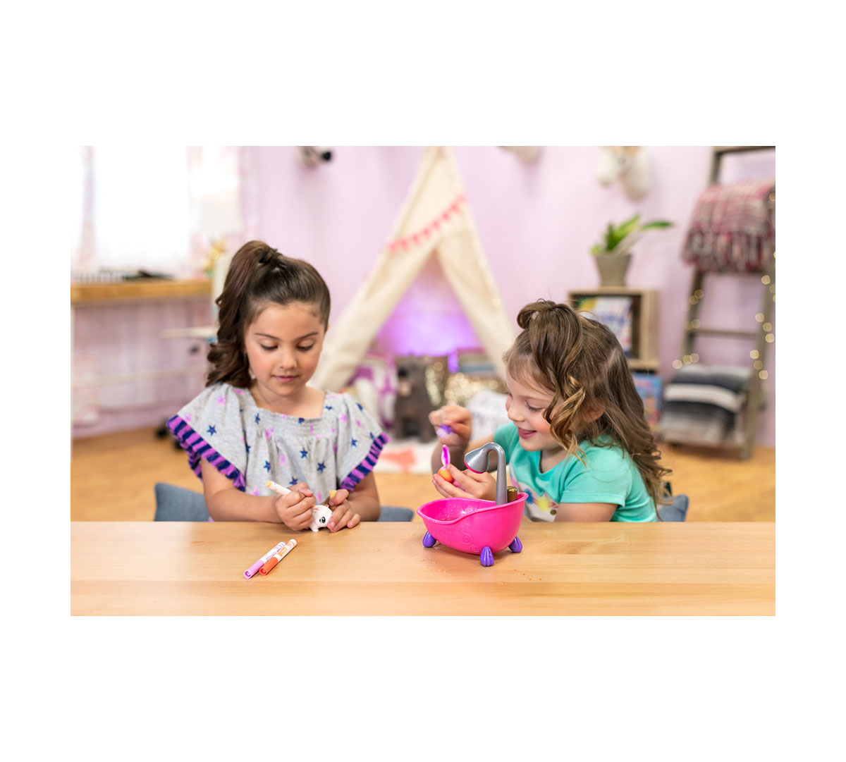 Two girls playing with Scribble Scrubbie Pets