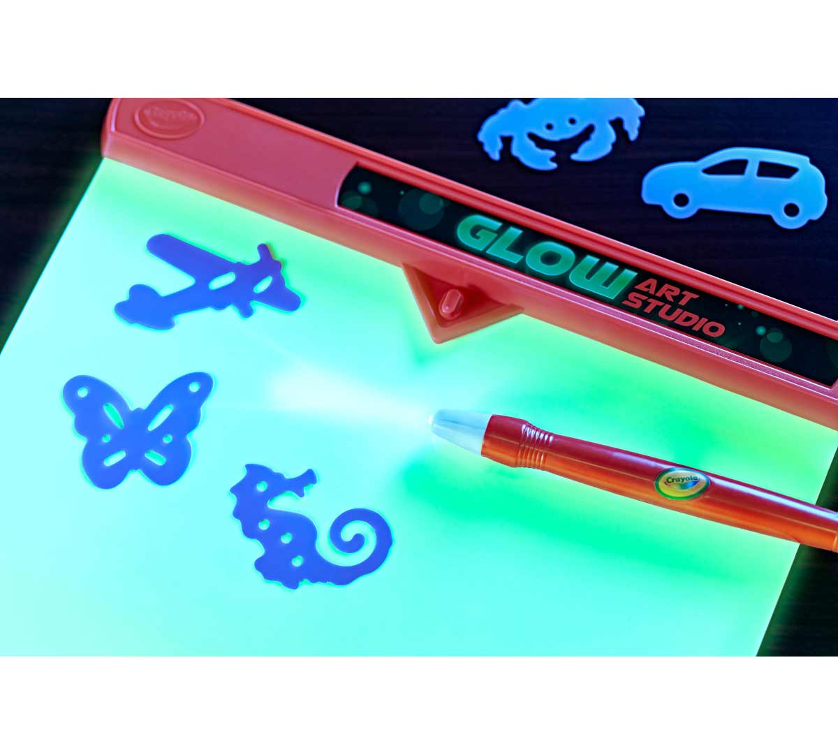 Glow Art Studio pen and stencils on top of glow pad.